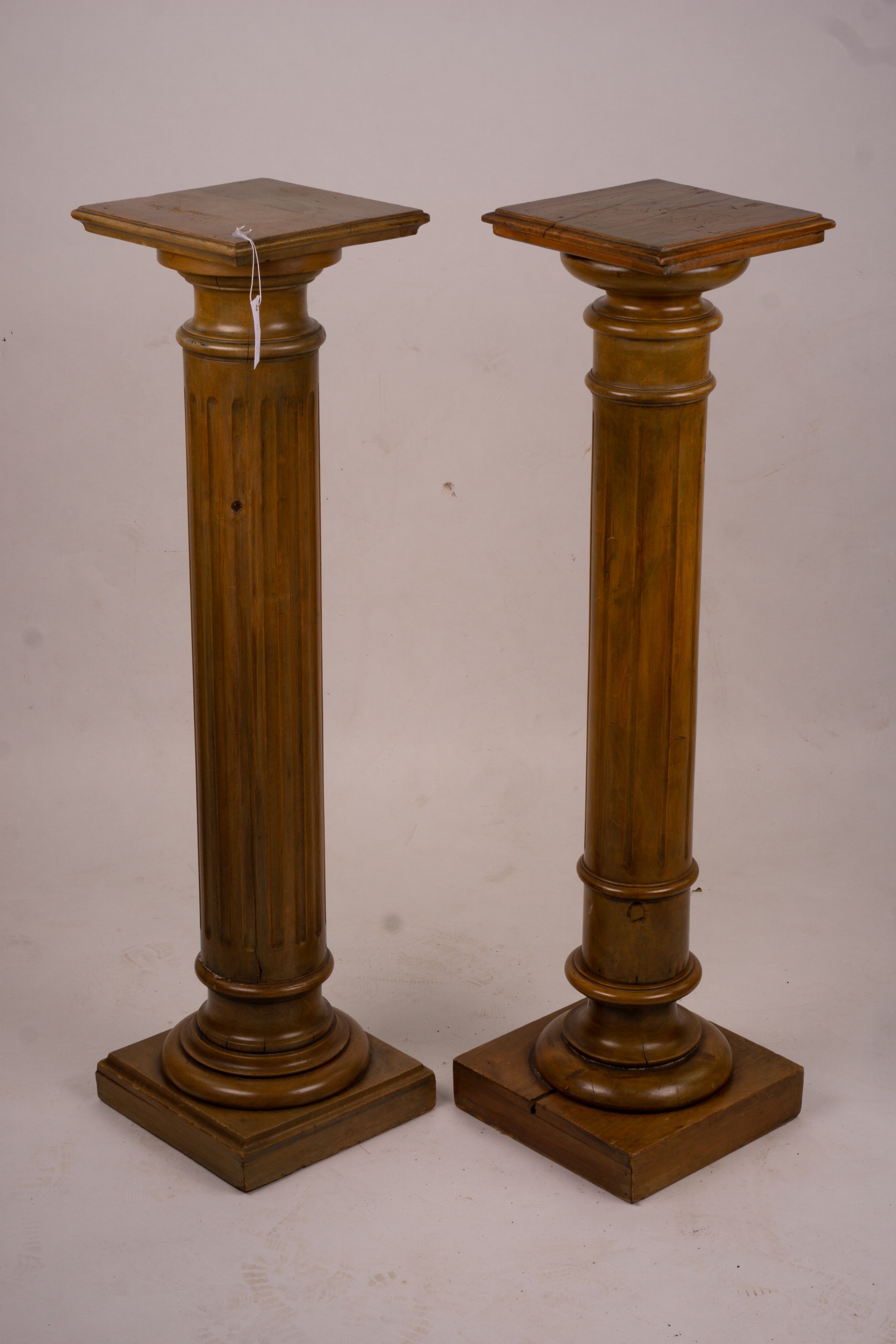 A pair of Victorian style carved beech and walnut pedestals, height 110cm